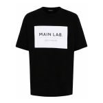 Balmain slogan-patch cotton T-shirt front view showing logo patch and cotton fabric detail