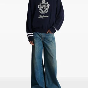 Back view of Balmain faded wide-leg jeans with wide-leg denim fit and faded blue wash detail