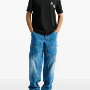 Back view of Balmain blue denim carpenter jeans showing rear pockets and carpenter denim design