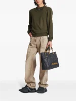 Balmain garment-dyed jeans back view showing rear pockets, designer detailing, premium denim construction, and garment-dyed fabric finish